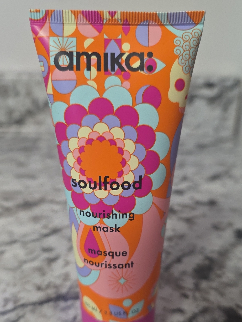 amika nourishing mask - orange tube with pink, lavender, mint and cream accents